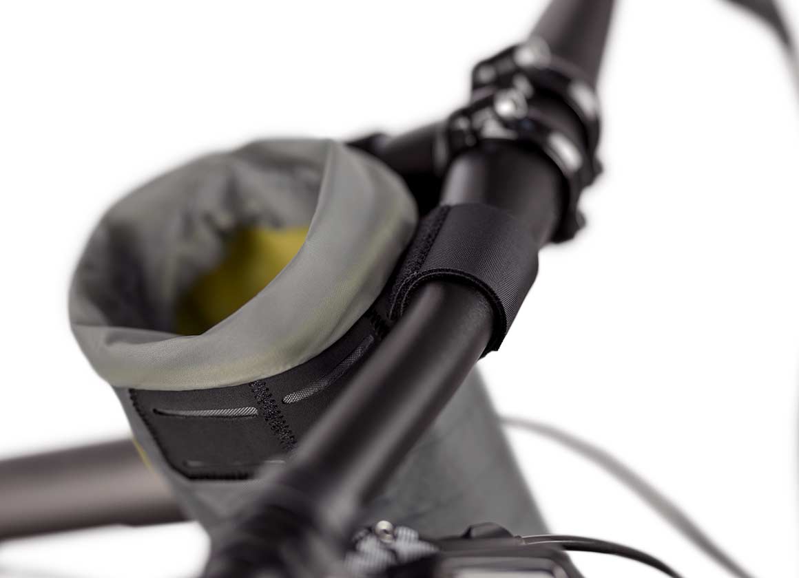 Apidura Backcountry Food Pouch on bike handlebars