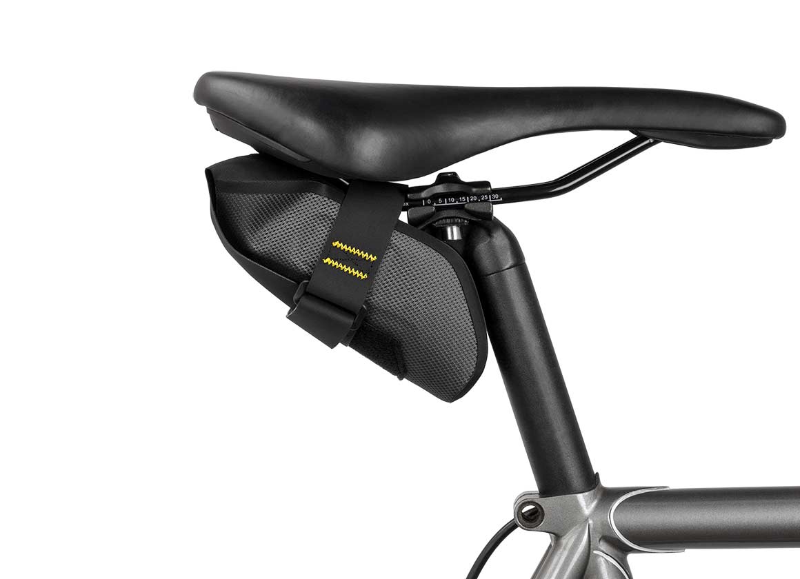 Apidura expedition tool bag attached underneath the bike seat from the side