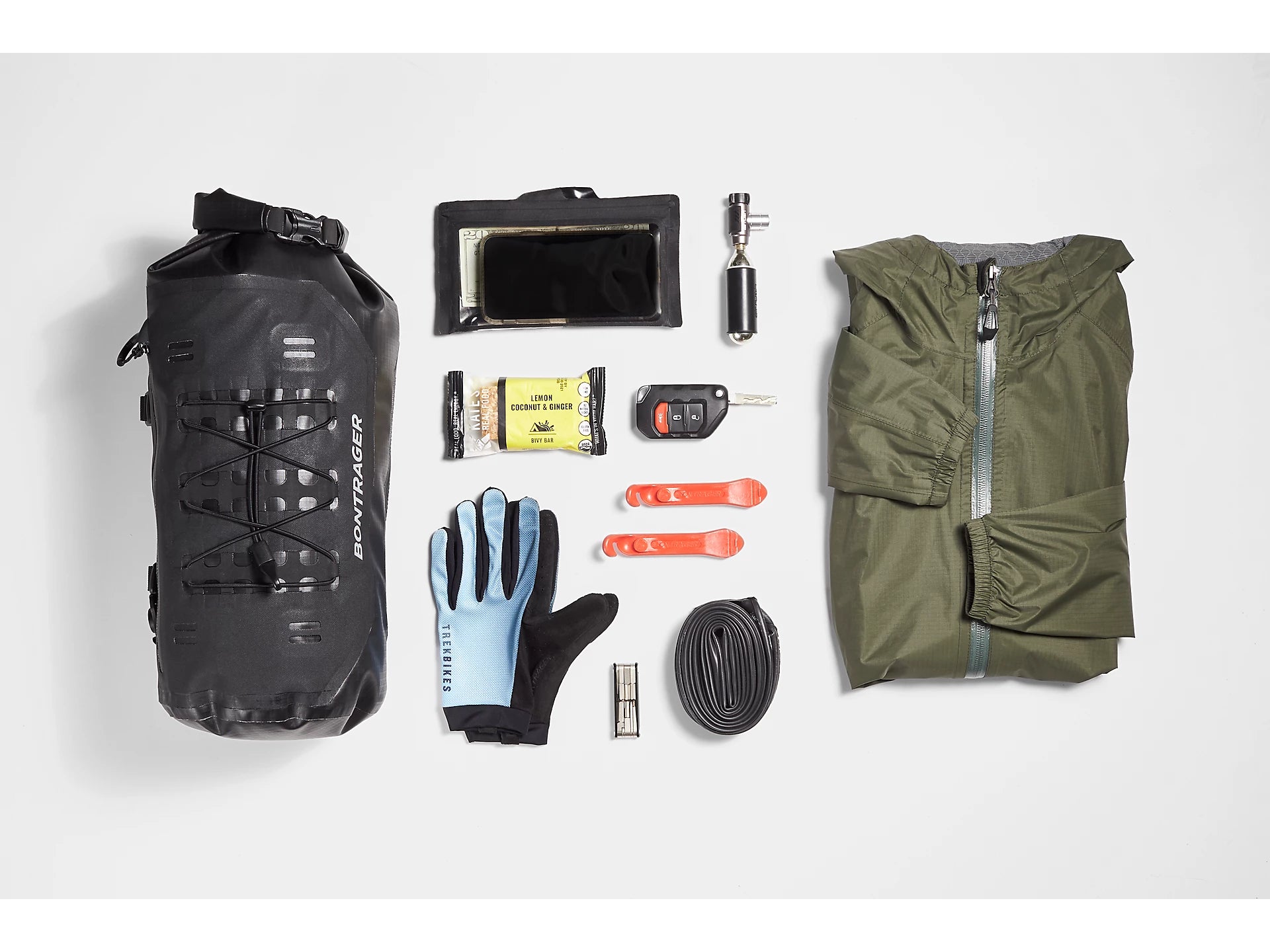 Bontrager Adventure Handlebar Bag 9L with accessories to show how much can fit in with a white background