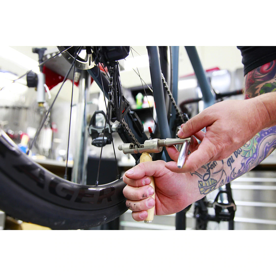 Lezyne Classic Chain Drive being used on a bike chain with a bike in the background