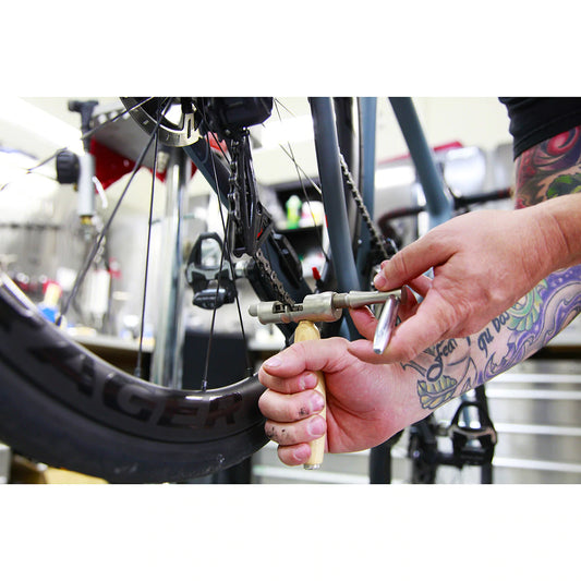 Lezyne Classic Chain Drive being used on a bike chain with a bike in the background