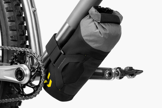 Apidura Downtube Pack on bike bar with a white background