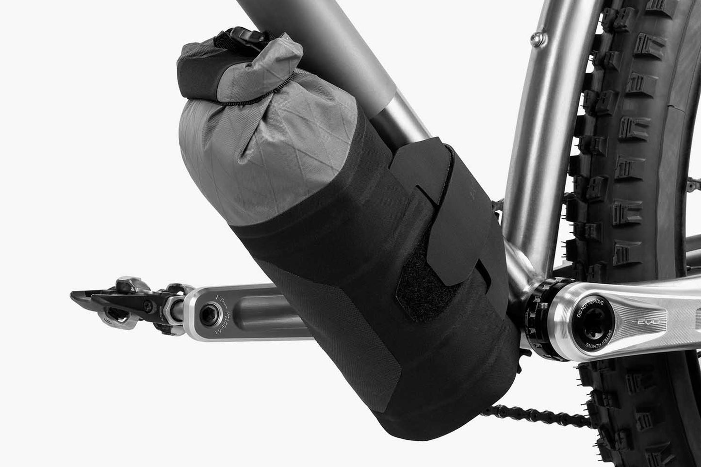 Apidura Downtube Pack on bike bar with a white background