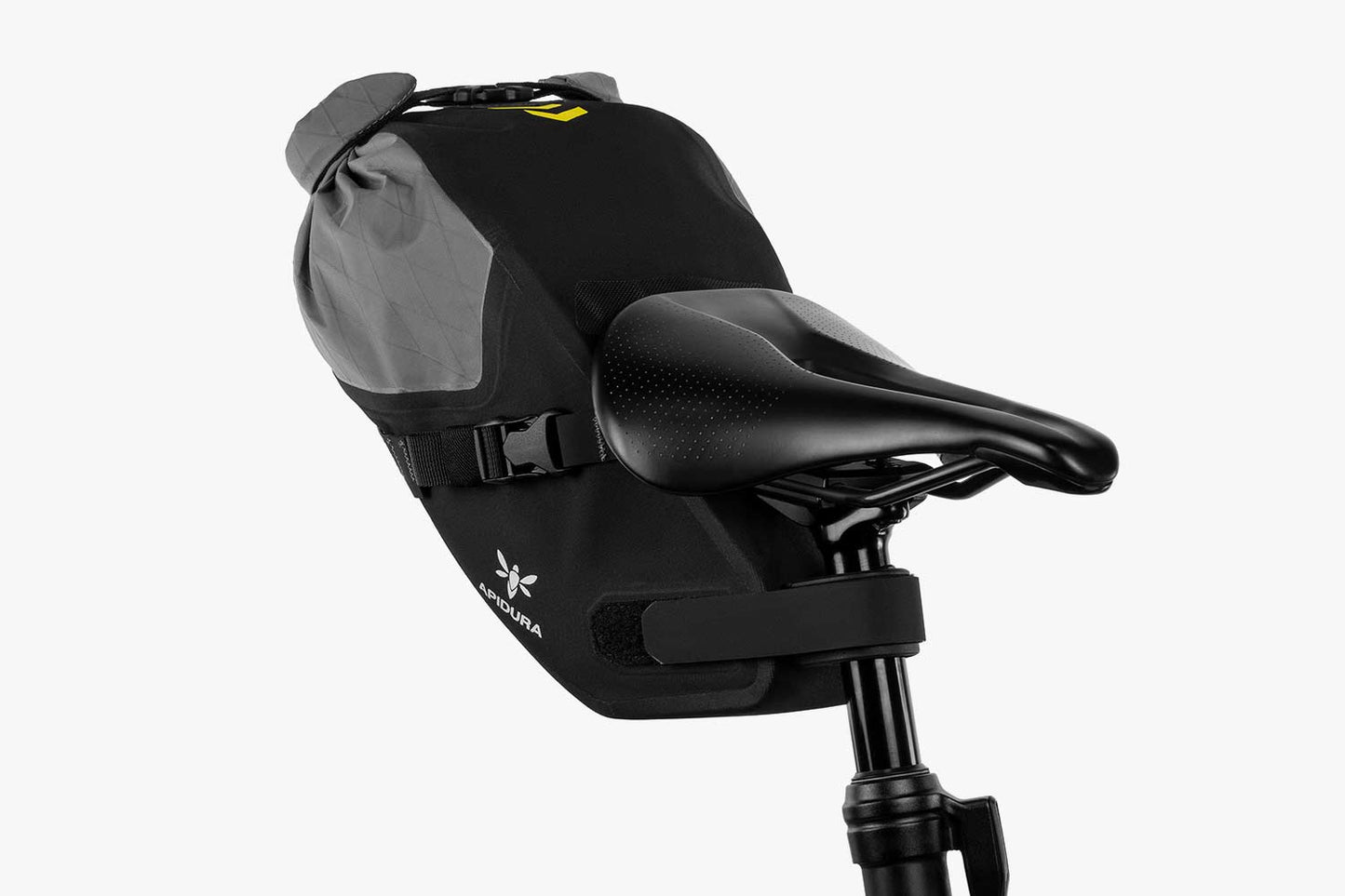 Apidura Backcountry Saddle Pack on the back of a bike with a white background