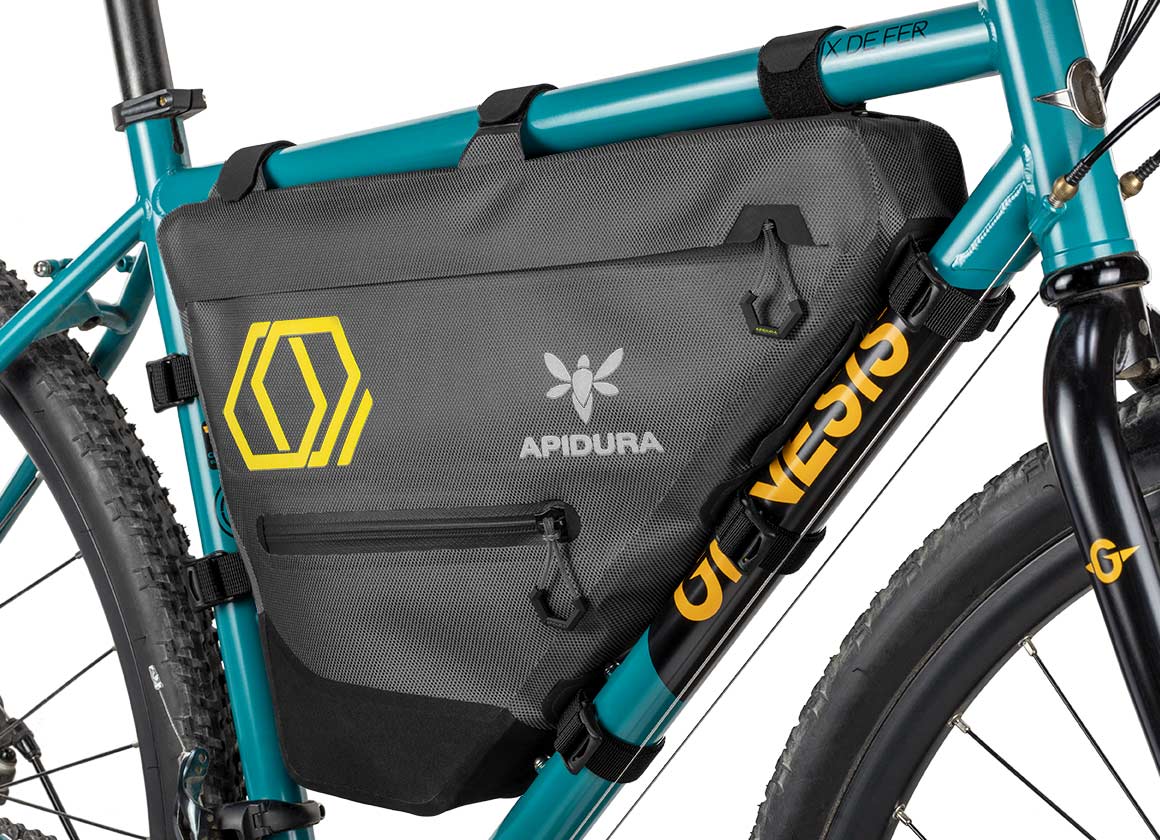 Apidura Full Frame Bag on a bikes bar with a white background