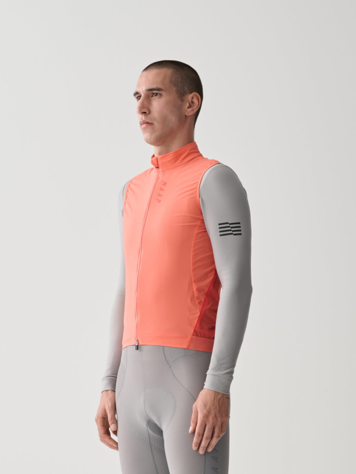 MAAP Team Flow Vest in Tangelo, gilet front worn by rider