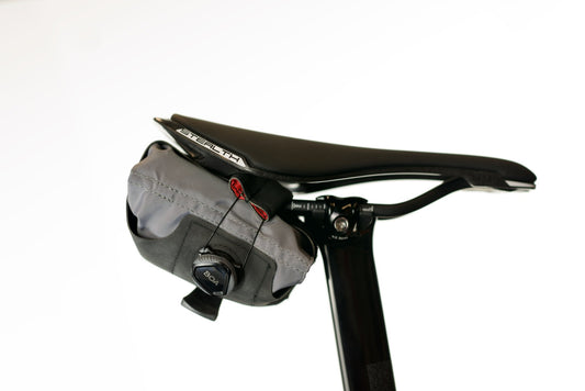Silca Asymmetrico Seat Roll on the back of a bike from the side on a white background